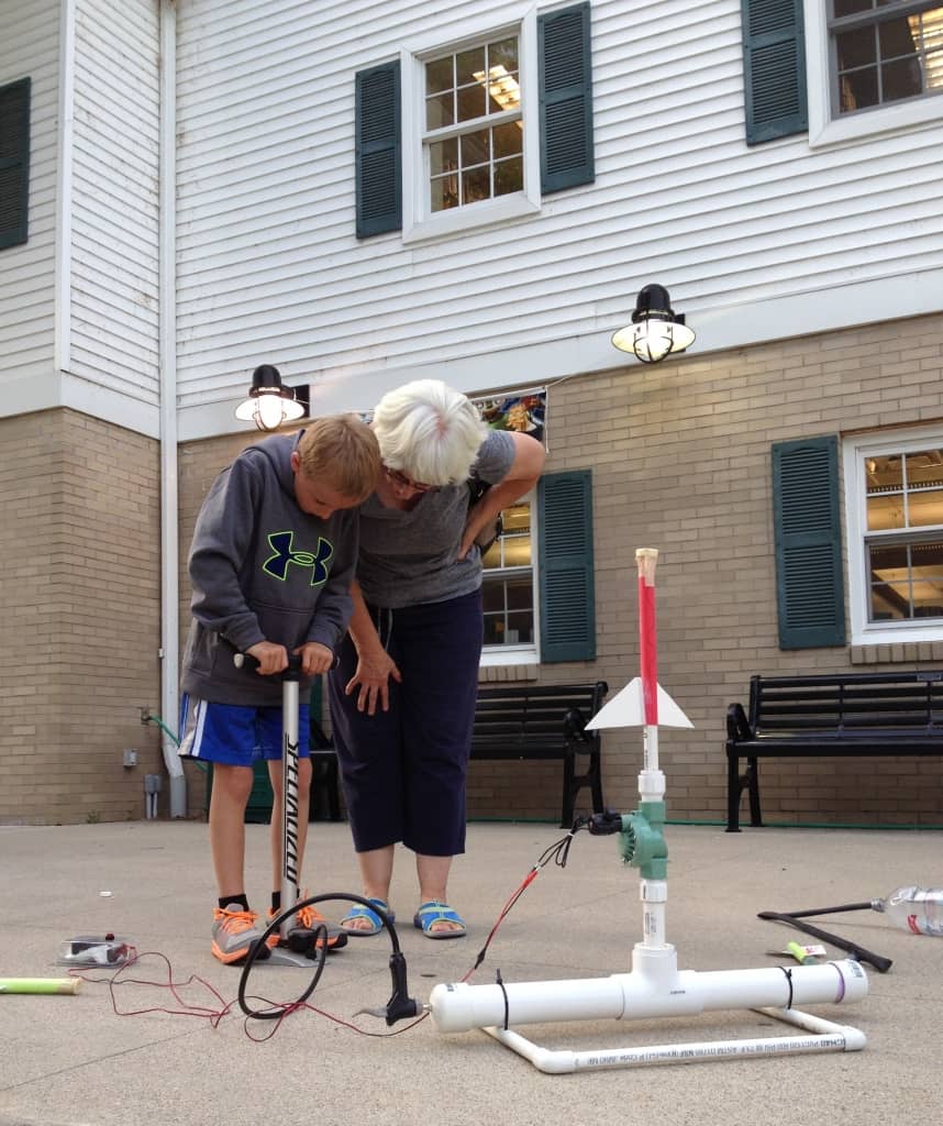 a paper rocket ready to be launched from the library patio,