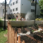 children watering a garden