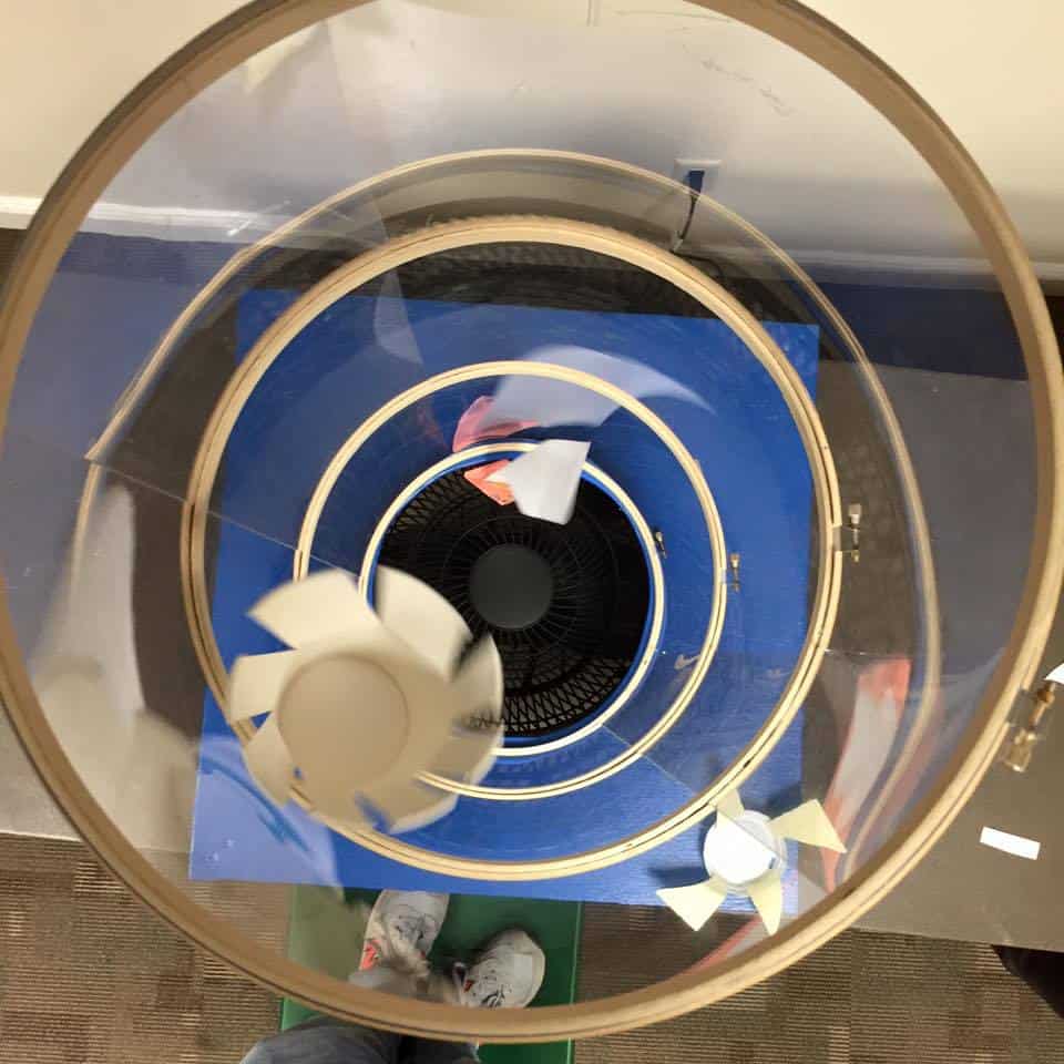 Vertical wind tunnel with flying paper objects