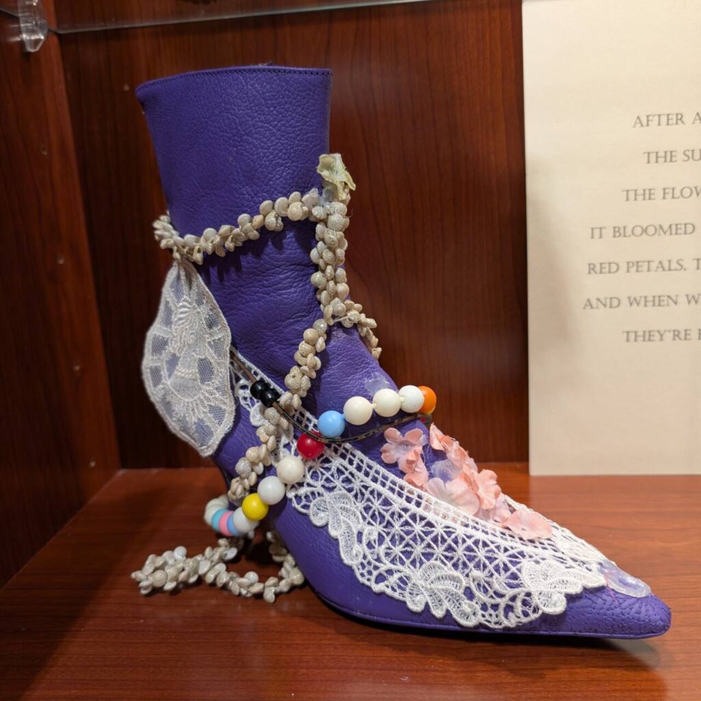 A purple boot adorned with lace.