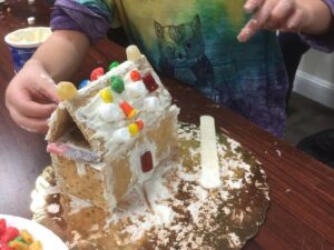 A house made from graham crackers, frosting, and candy.