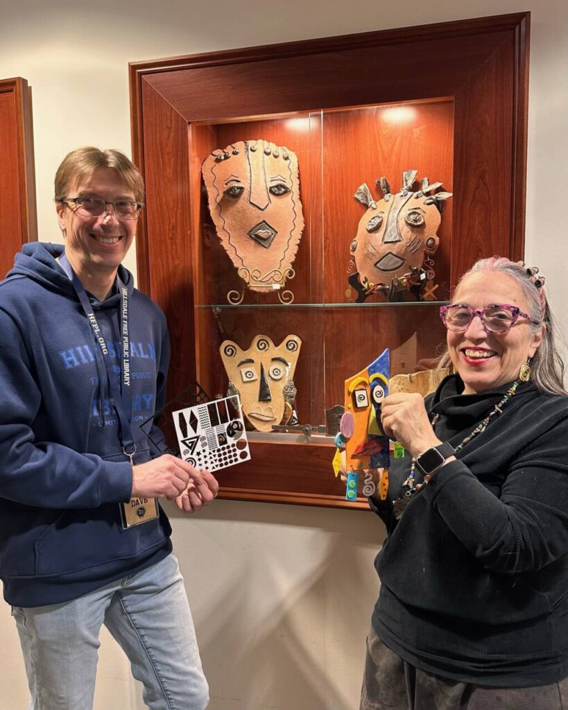 Dave Franz and Susie Gerace in from of library display case