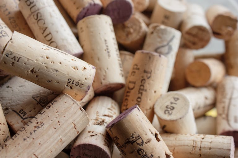 A detailed close-up of various wine corks with visible impressions and textures.