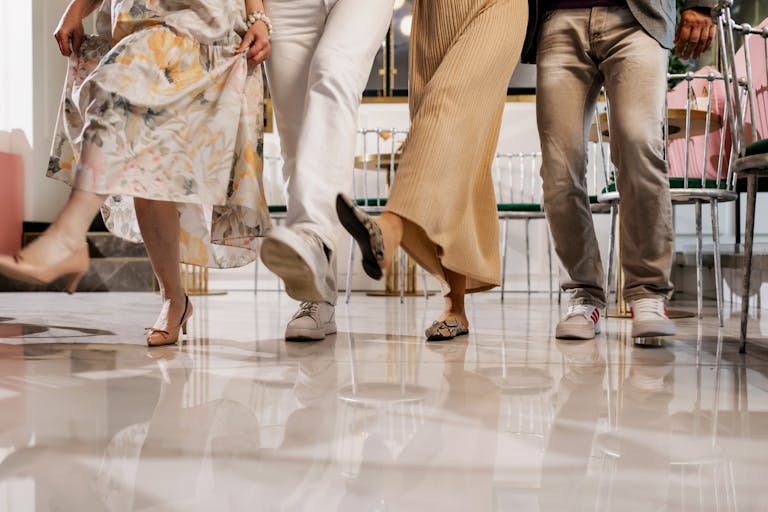 A group of people elegantly dancing together indoors, showcasing friendship and joy.