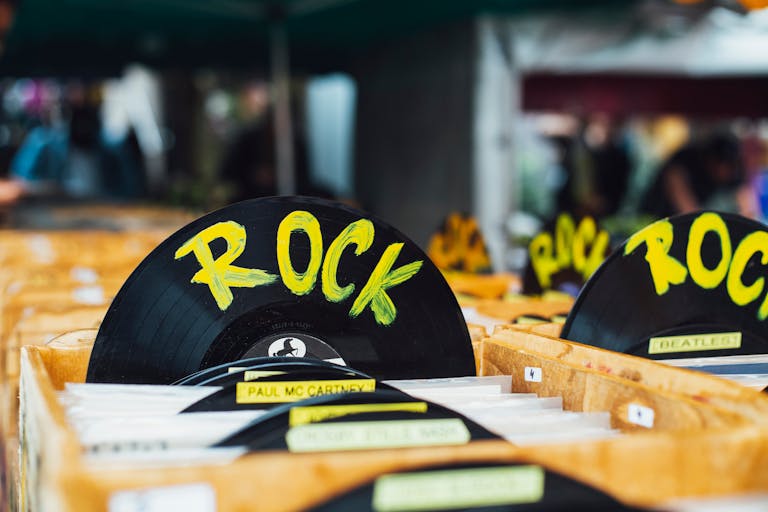 Colorful vinyl records labeled 'Rock' in a vintage music shop, perfect for music enthusiasts.