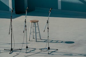 A serene outdoor stage setup featuring a bar stool and microphones in Vancouver, Canada.