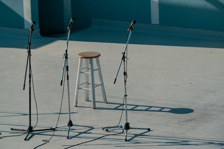 A serene outdoor stage setup featuring a bar stool and microphones in Vancouver, Canada.