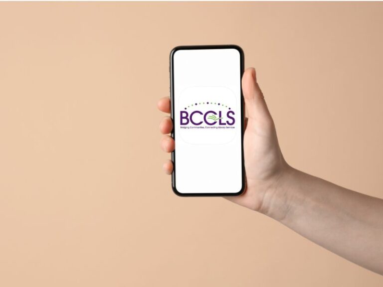 Hand holding mobile phone with BCCLS app icon on phone screen