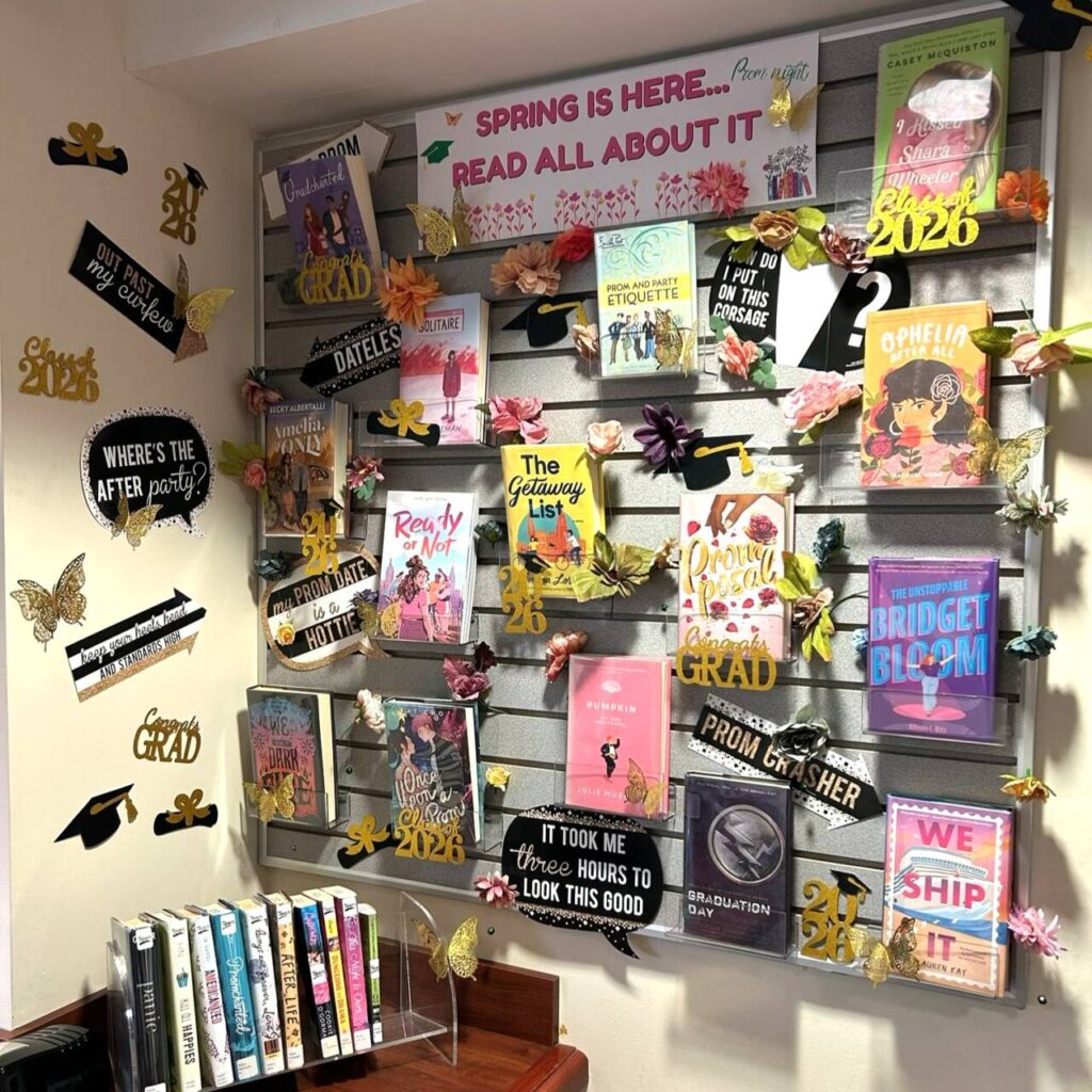 Teen book display at the Hillsdale Library with a teen Spring theme, including prom, graduation, flowers, and butterflies
