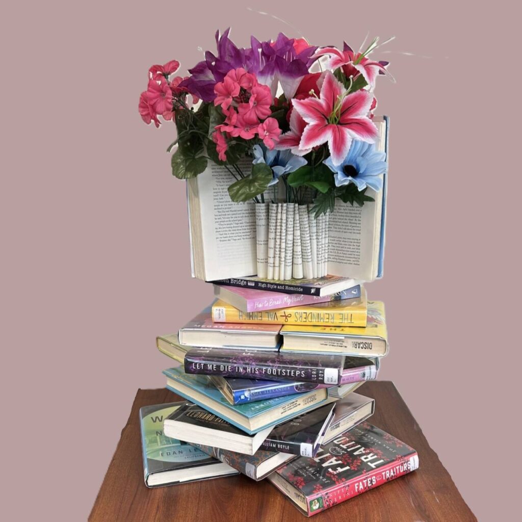 Spring flowers in a vase created from folded and stacked used books