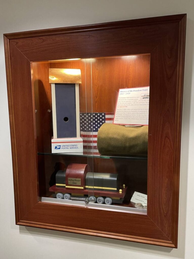 Display case at HFPL with wooden trains crafted by Nicholas Anthony Orlando