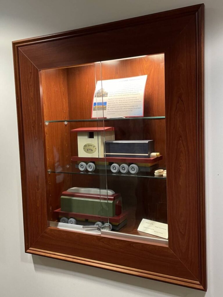 Display case at HFPL with wooden trains crafted by Nicholas Anthony Orlando