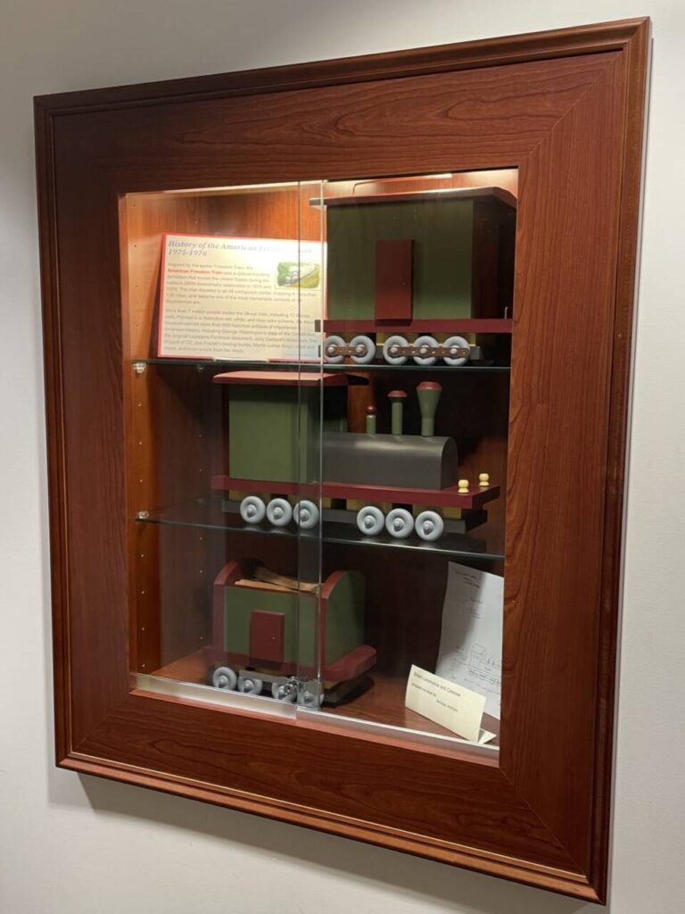 Display case at HFPL with wooden trains crafted by Nicholas Anthony Orlando