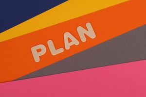 Vibrant geometric colored background with the word 'Plan' in bold letters.