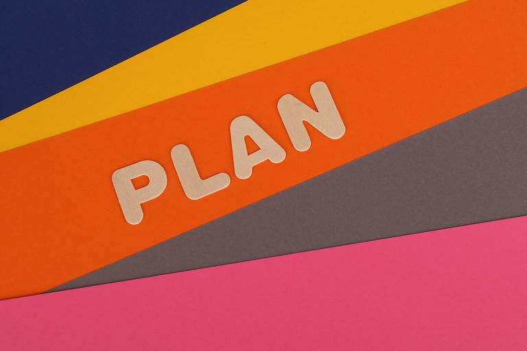 Vibrant geometric colored background with the word 'Plan' in bold letters.