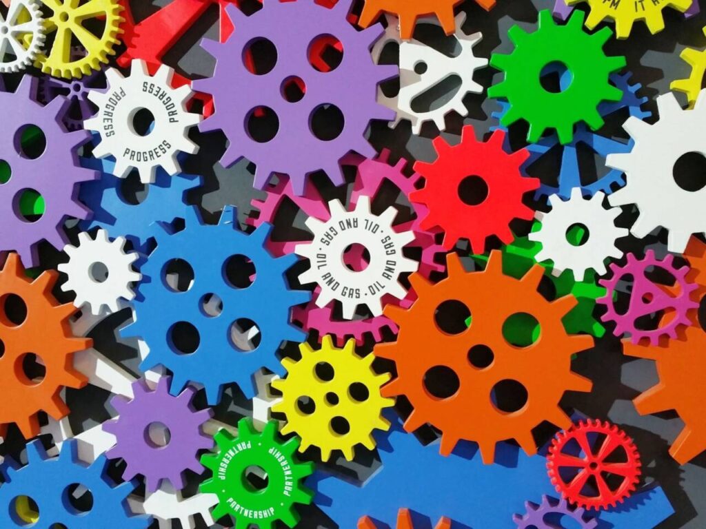 Pile of colorful gears to inspire Tinkering Tuesdays creativity